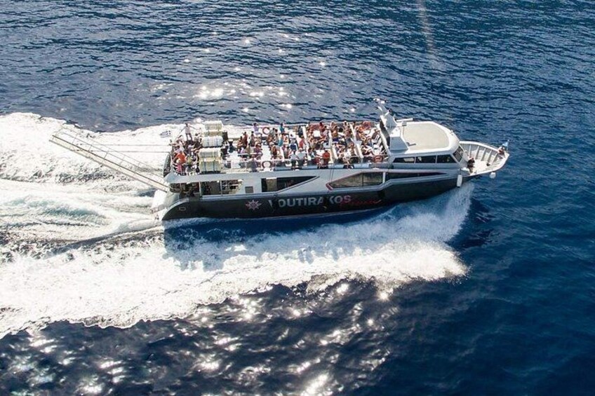 A large boat with the name 'OUTIRA COS' sailing on the ocean. 1