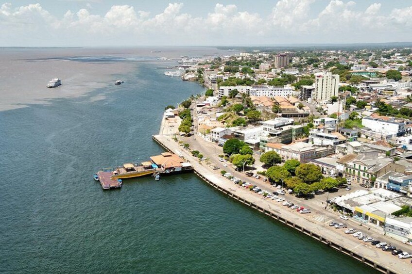 A coastal city with a marina, buildings, and a clear sky. 2