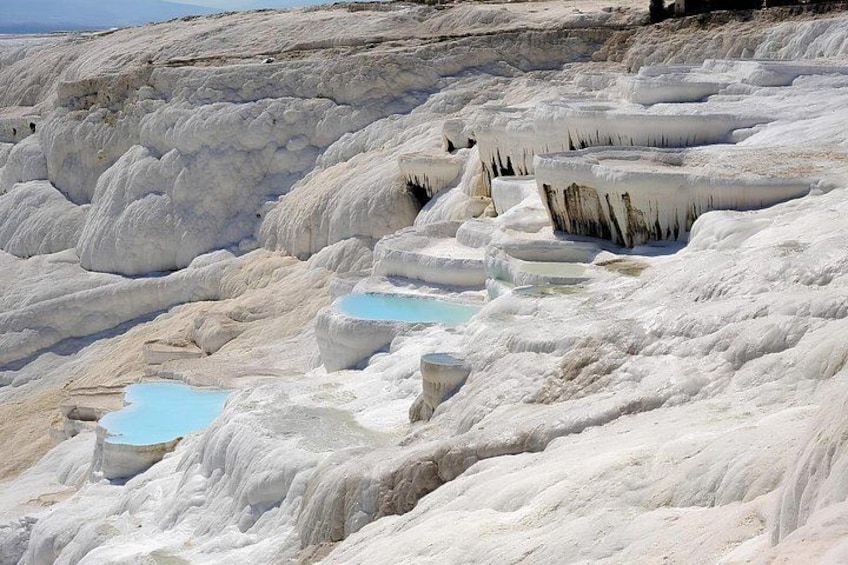 Terraced travertine formations with pools of water. 1