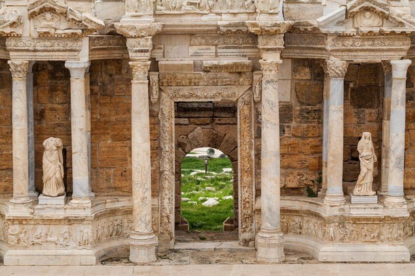 A historical building with columns and statues. 3