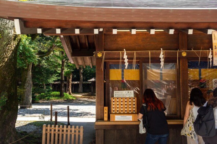 A wooden structure with a signboard, surrounded by trees. 5