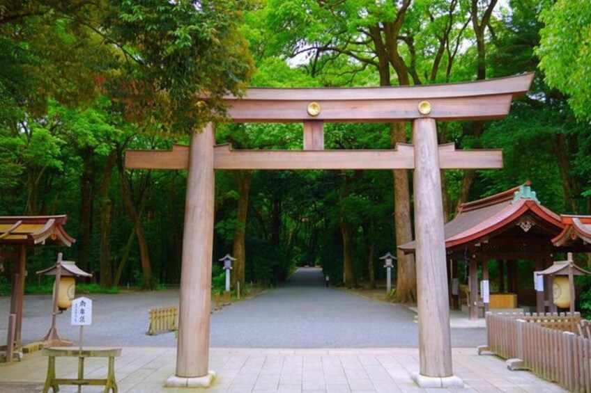 A traditional Japanese torii gate in a forested area with a pathway leading through it. 2