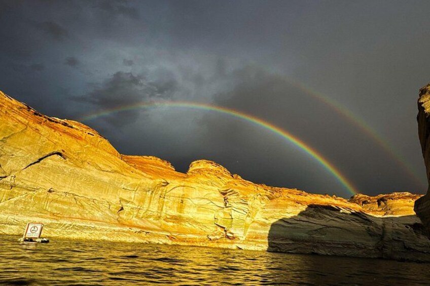 A rocky landscape with a rainbow over a body of water. 4