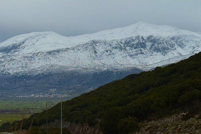 A snow-covered mountain range with a valley in the foreground. 2