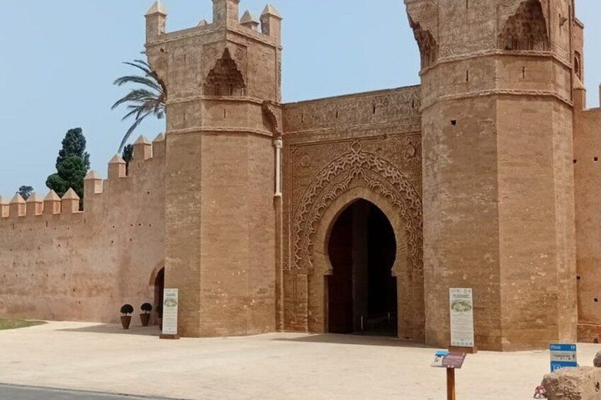 A historic building with a large arched entrance, two towers, and a decorative facade. 4