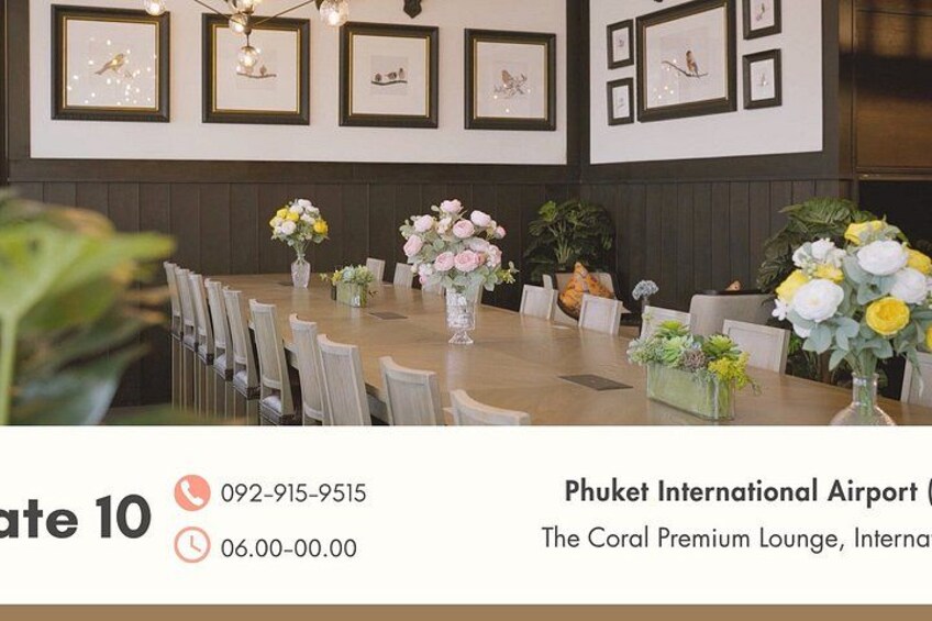 A dining area with a long table set for 10 people, framed artwork on the wall, and potted plants. 4