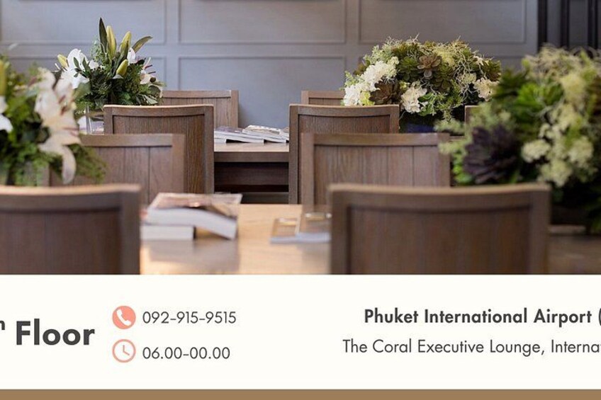 A conference room with wooden chairs and tables, decorated with floral arrangements. 5