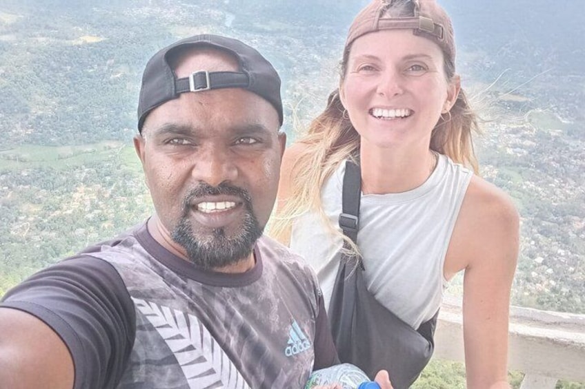 Two people taking a selfie with a mountainous landscape in the background. 2