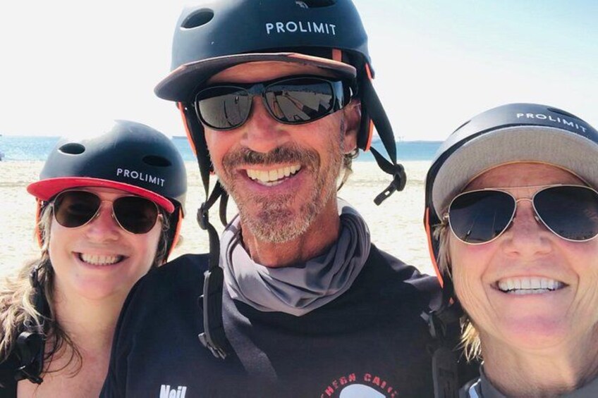 Three people wearing helmets with the brand 'PROLIMIT' on a beach. 5