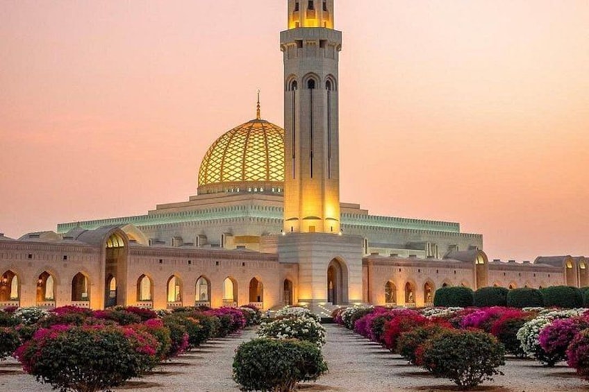 A mosque with a large dome and a tall minaret, surrounded by well-maintained gardens. 1