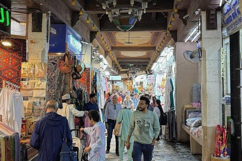 A crowded market with people browsing and shopping. 2