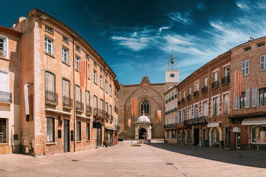 Place de la Loge: The historic heart paved with pink marble, surrounded by the City Inn and the Palais de la Députation. 2