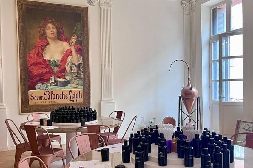 A room with a large poster, a table with bottles, and a tall red object. 5