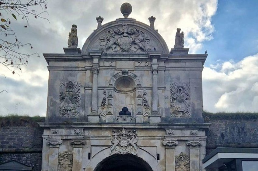 A historical stone monument with intricate carvings and a dome. 5