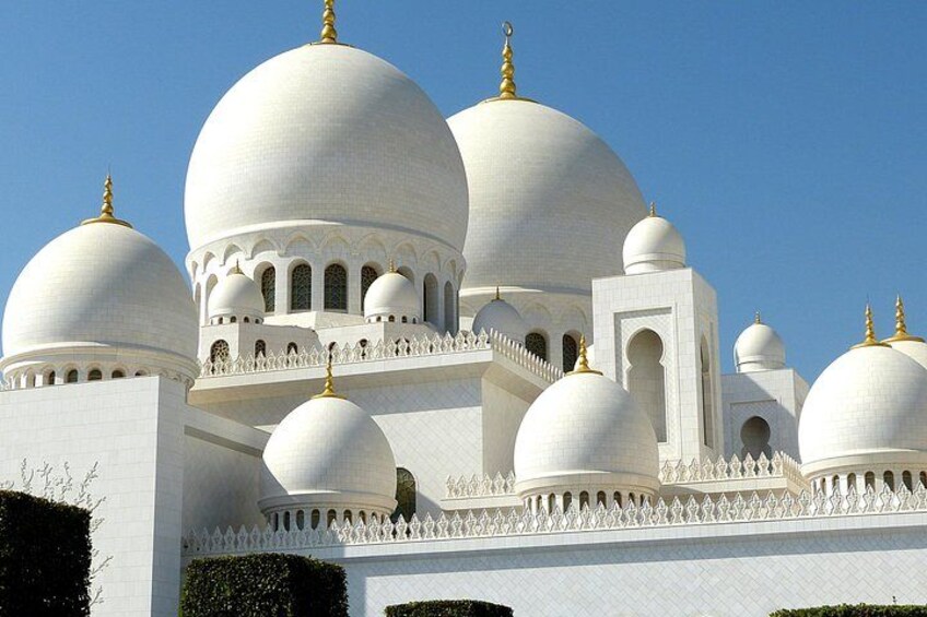 A white building with multiple domes and golden spires. 2