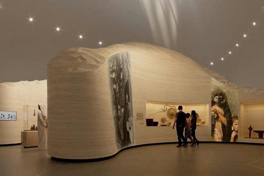 A modern art installation with a large, curved structure and a mural. 5