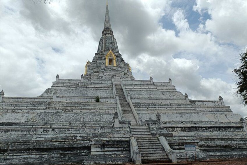 A large, ancient temple with a tall spire and multiple levels of steps leading up to it. 5