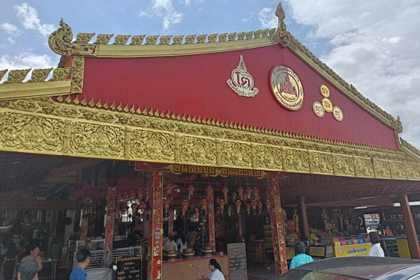 A temple with ornate golden decorations and a red roof. 3