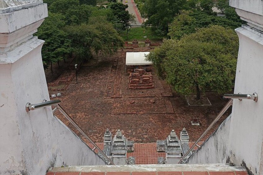A temple complex with a central stupa, surrounded by trees and brick structures. 4