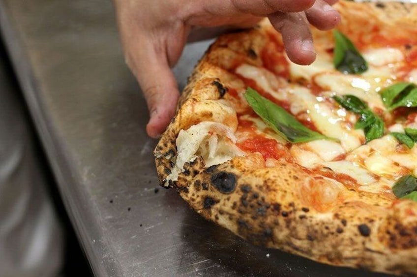 A pizza with visible toppings and a crust. 2