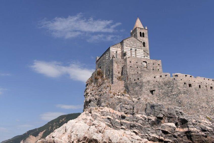 A historic stone castle perched on a rocky cliff. 3