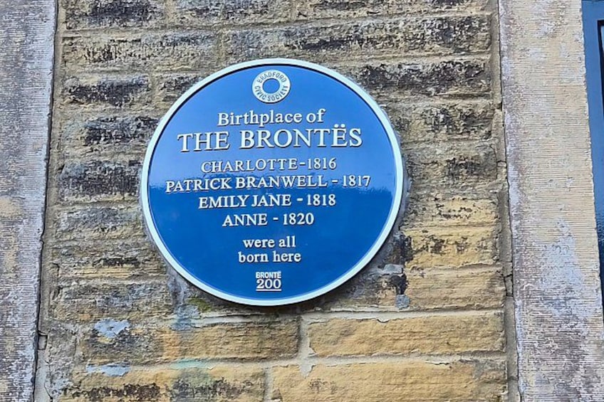 A blue plaque on a brick wall. 2