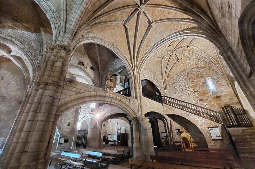 A cathedral interior with high vaulted ceilings, arched windows, and a central aisle. 2