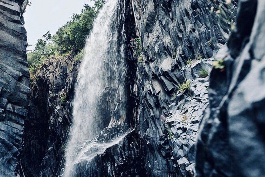 A waterfall cascading down a rocky cliff. 2