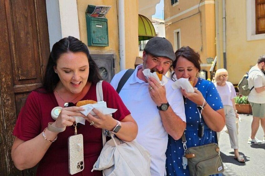 People eating food on a street. 5