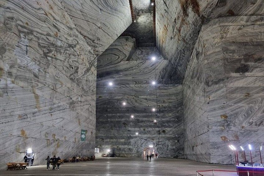 A large, cavernous interior with marble walls and a high ceiling. 1