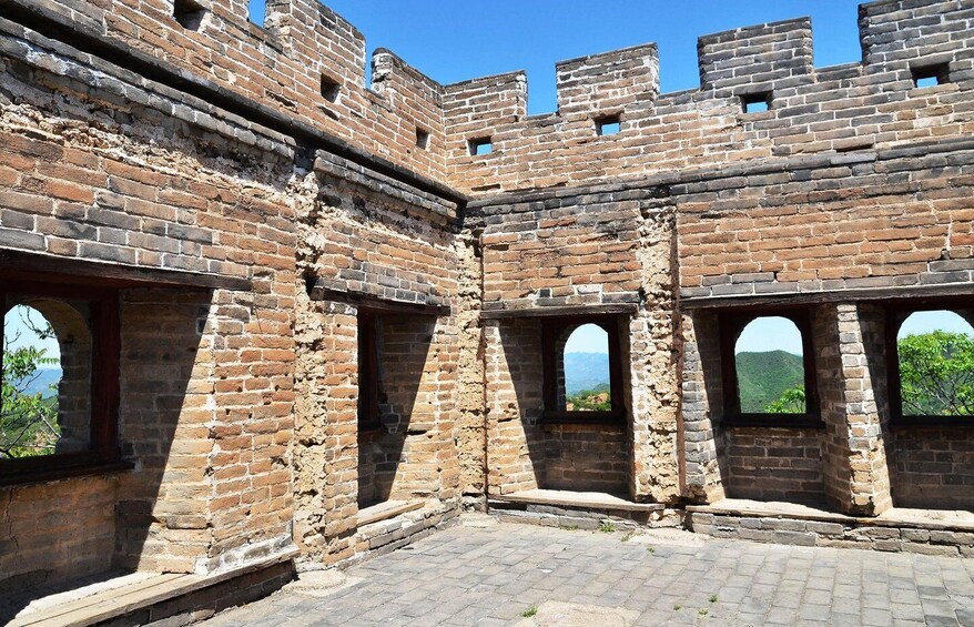 A section of the Great Wall of China with brick walls and arched windows. 5