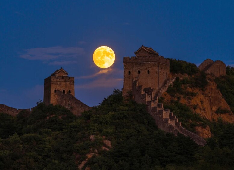 The Great Wall of China with the moon in the sky. 3