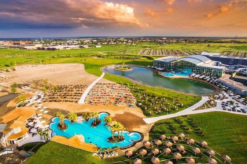 A resort with a large swimming pool, a tennis court, and a golf course. 2