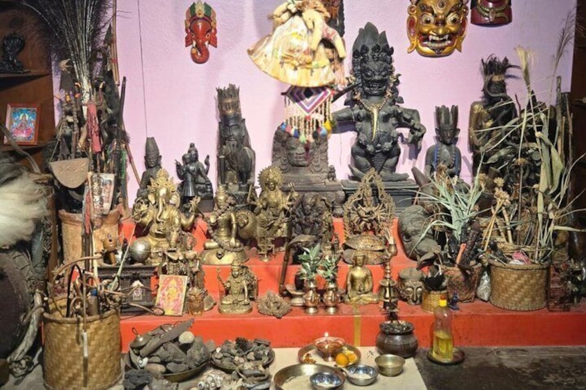 A collection of statues and religious artifacts on a table. 1