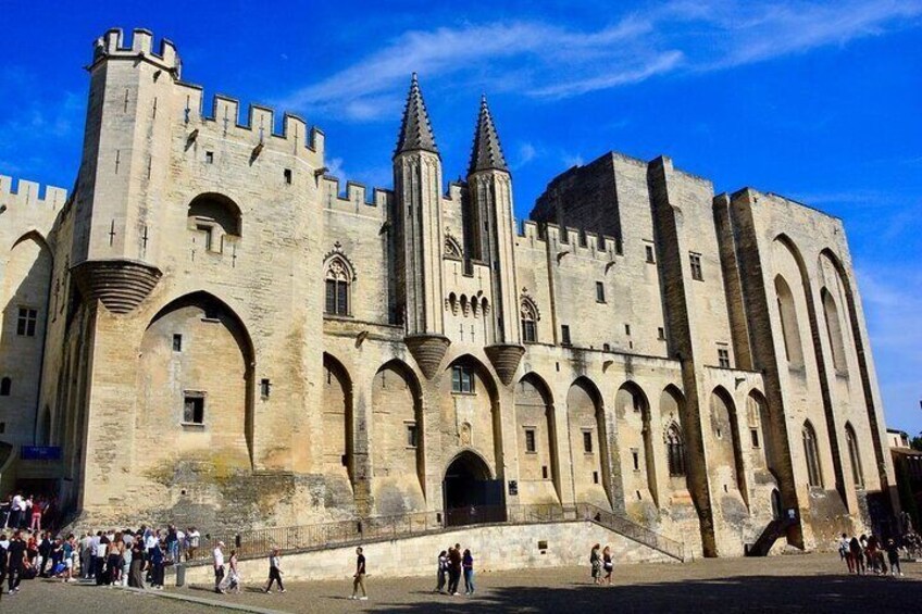 A historic stone building with arched windows and a central tower. 1