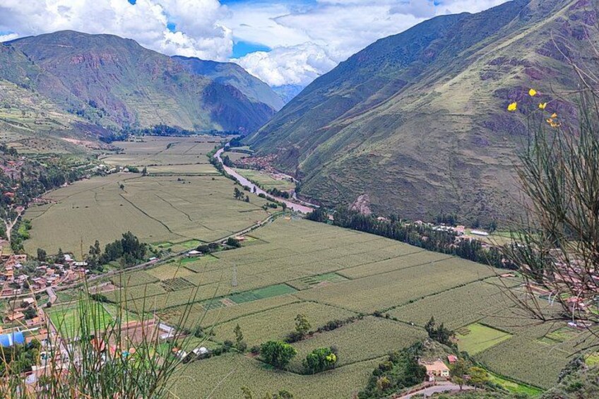 A valley with terraced fields, a river, and mountains. 5