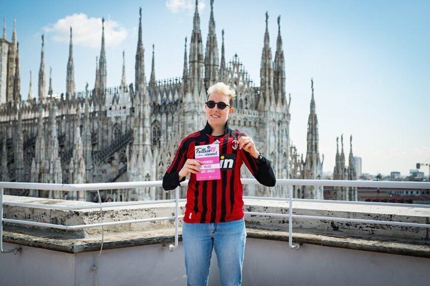 A person standing on a bridge with a historic cathedral in the background. 2