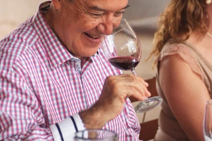 A person holding a wine glass. 3