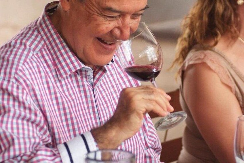 A person holding a wine glass, wearing a checkered shirt. 3