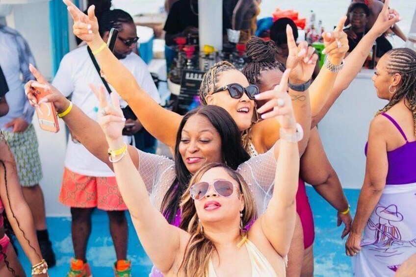 A group of people at a poolside event, some making peace signs. 2