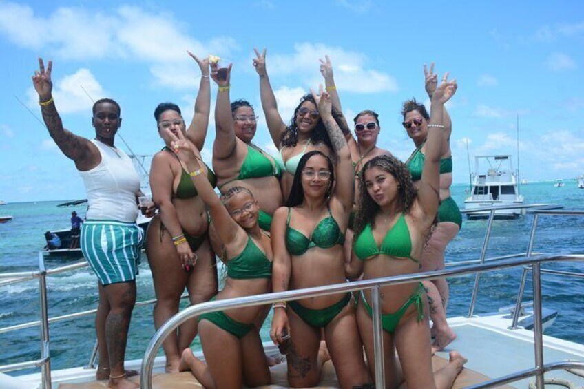 A group of people on a boat with the ocean and a clear sky in the background. 4