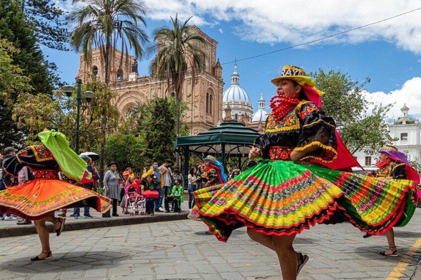 A person in a colorful traditional dress, palm trees, and a historic building in the background. 2