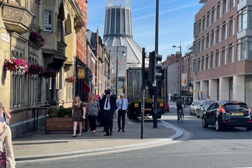 A street with pedestrians, a bus, and cars. 4