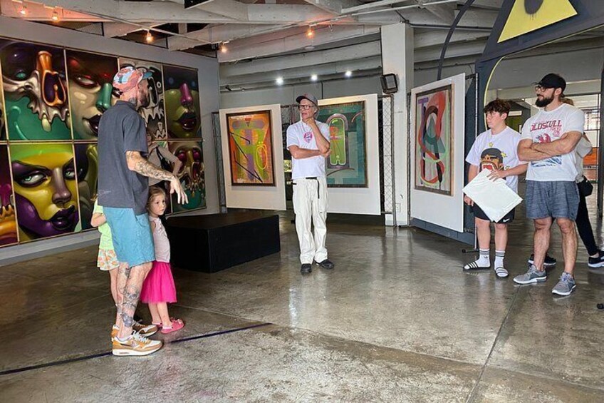 An art gallery with abstract paintings on the walls. 3
