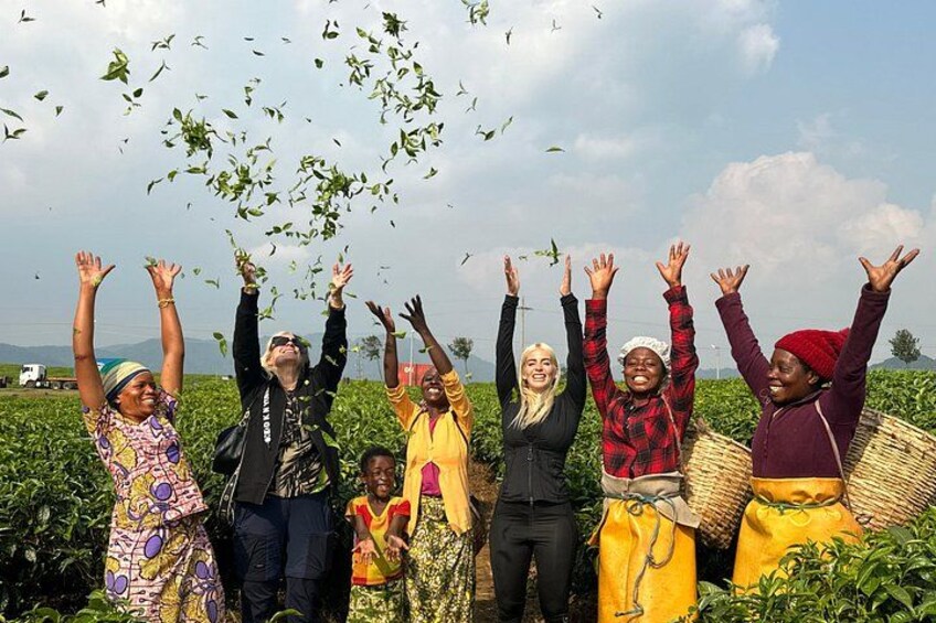 A group of people in a field with raised hands, possibly celebrating or harvesting crops. 3