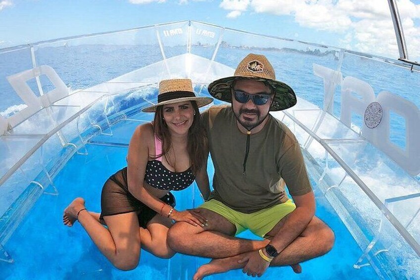 A couple on a boat with a clear blue sea and sky in the background. 5
