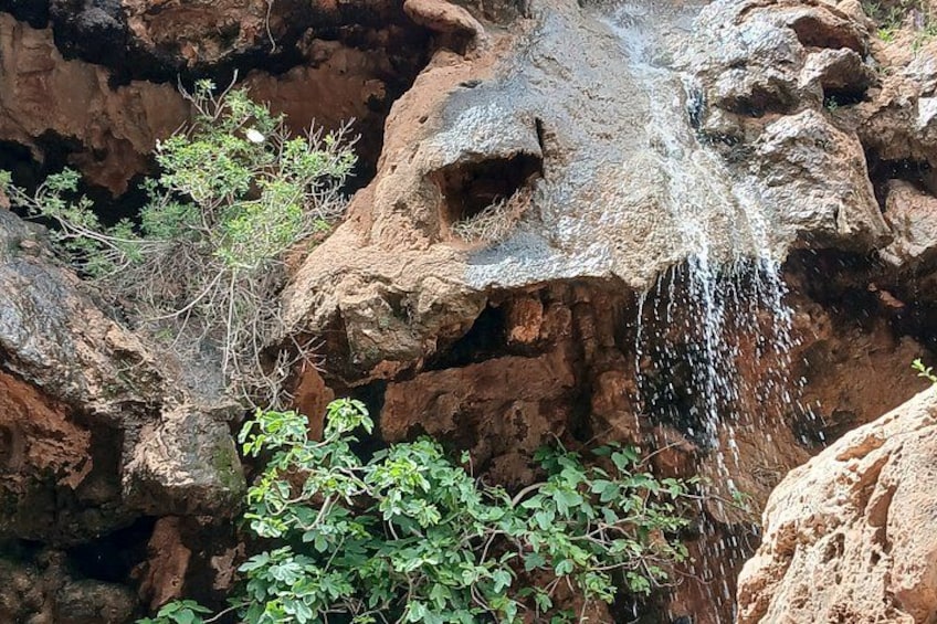 A rocky waterfall with greenery around. 5