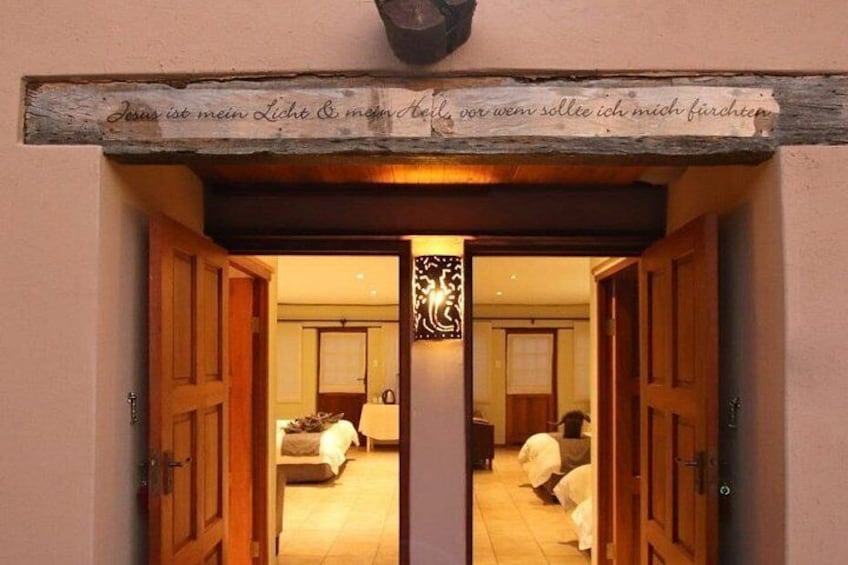 A doorway with a wooden frame and a sign above it. 5
