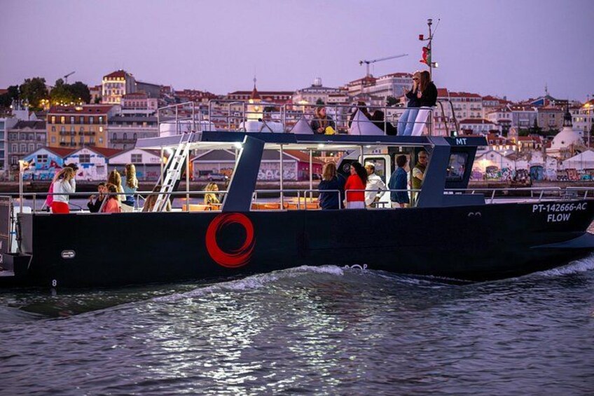 A boat with people on board, a lifebuoy, and a cityscape in the background. 4