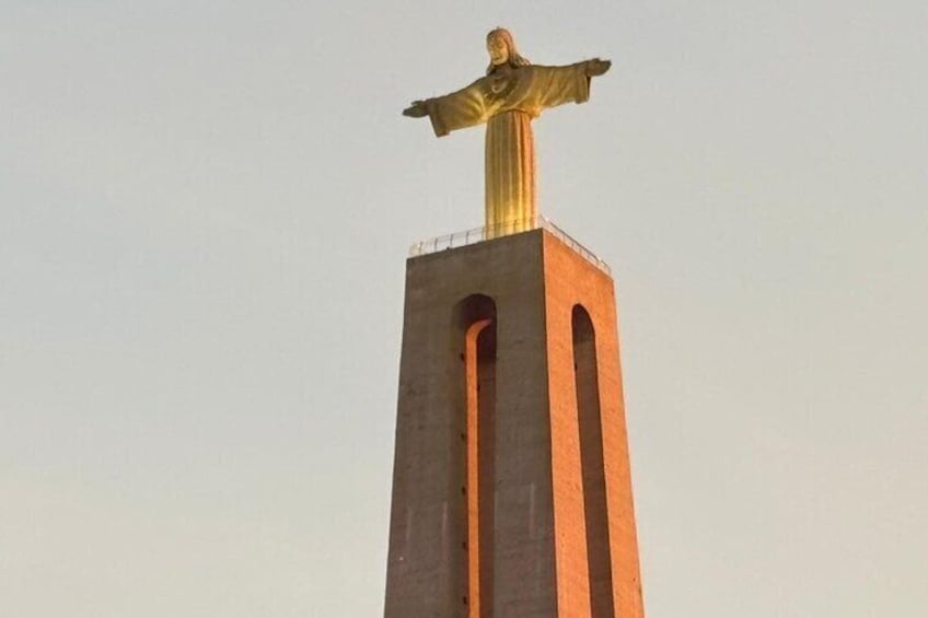 A statue on a tall, rectangular pedestal with arched openings. 2